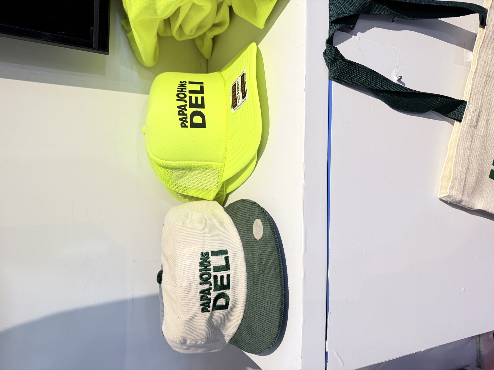 Finished shirts, hats, and event merch on display for Event Heat Press
